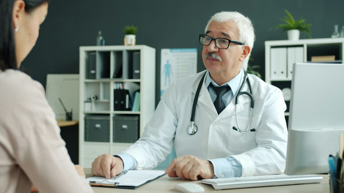 Doctor consulting with a patient at a clinic desk